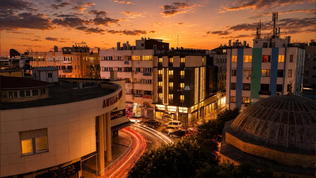 a city skyline with buildings and traffic at sunset at The Rizon Hotel in Antalya