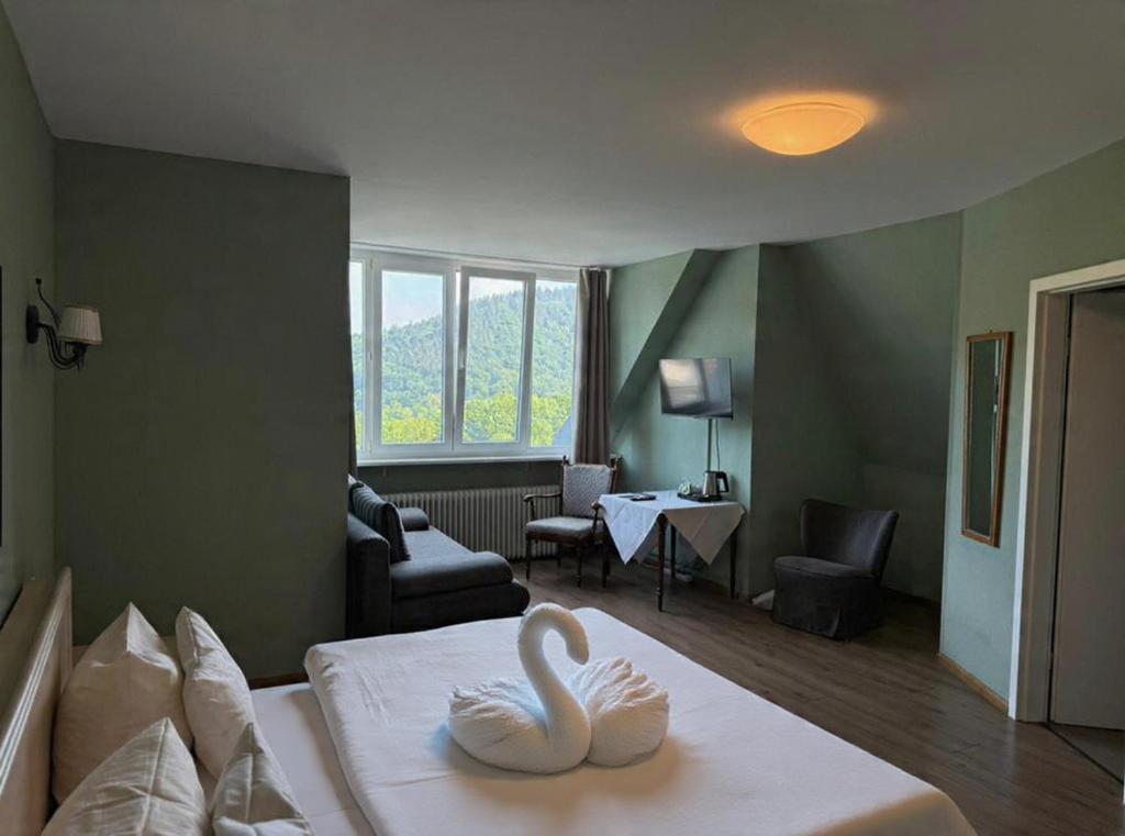 a hotel room with two swans on a bed at Hotel Markgräfler Hof in Badenweiler