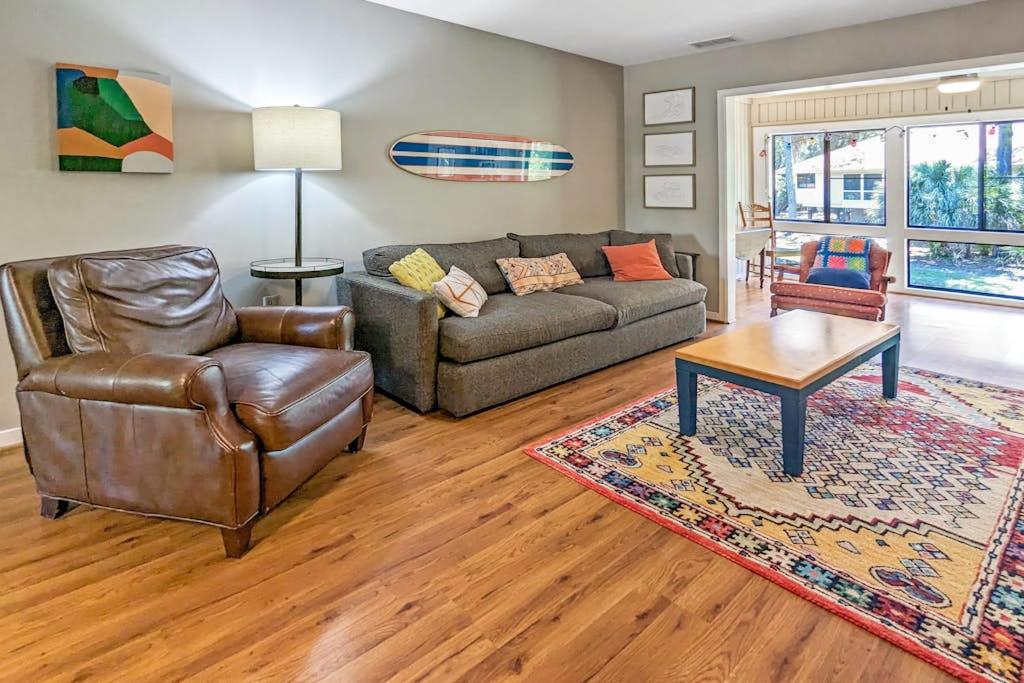 a living room with a couch and a chair at The Pirate Den in Edisto Beach