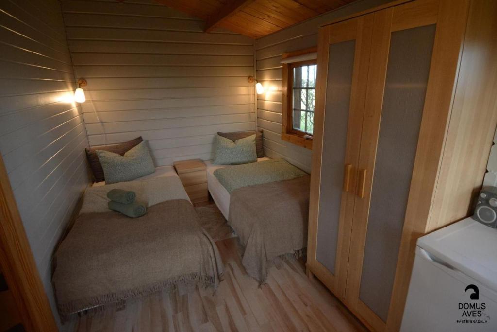 a small room with two beds and a window at Egilsstadir 1, Skógarkot, Urridafossvegur, Selfoss in Selfoss