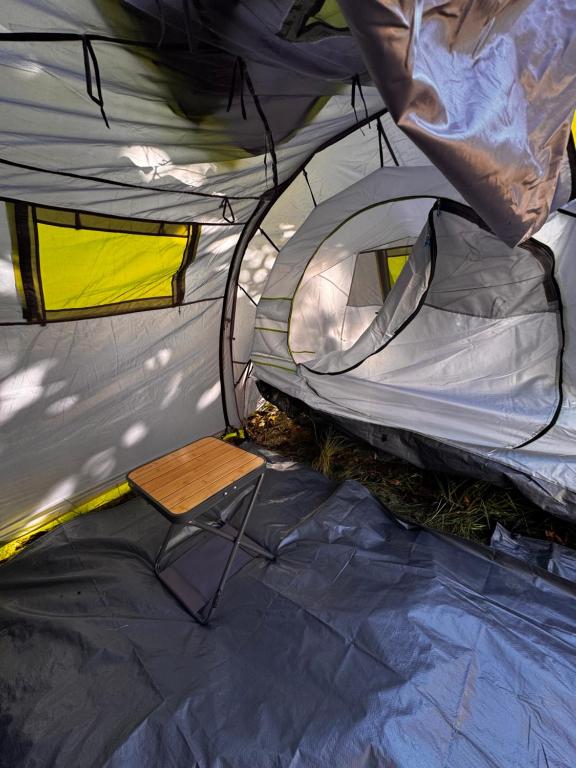 a tent with a wooden table and a chair in it at Pey camp in Saubion
