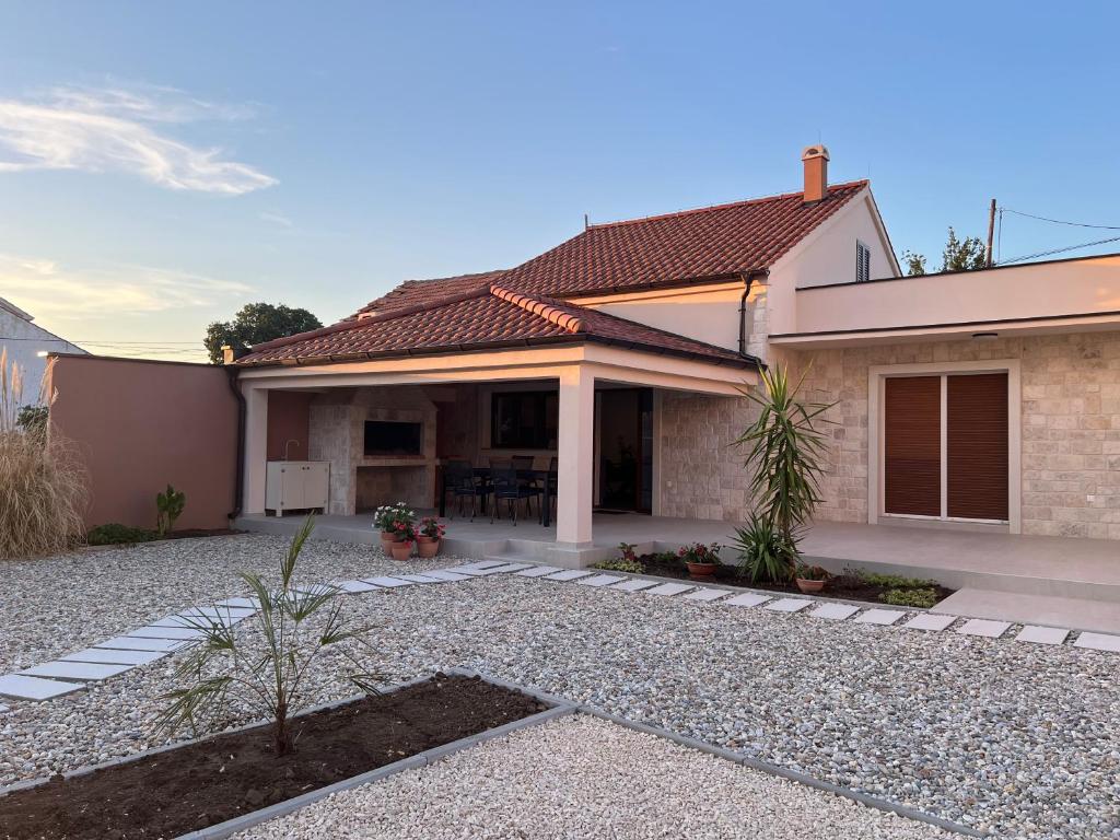 a home with a patio and a house at Šaravanja in Bibinje