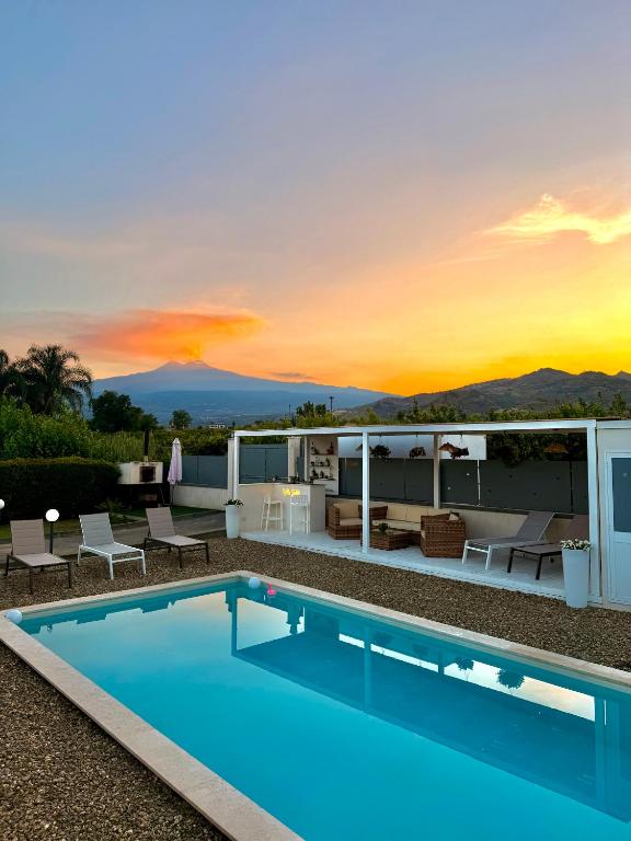 a villa with a swimming pool at sunset at Villa Sidoti in Calatabiano