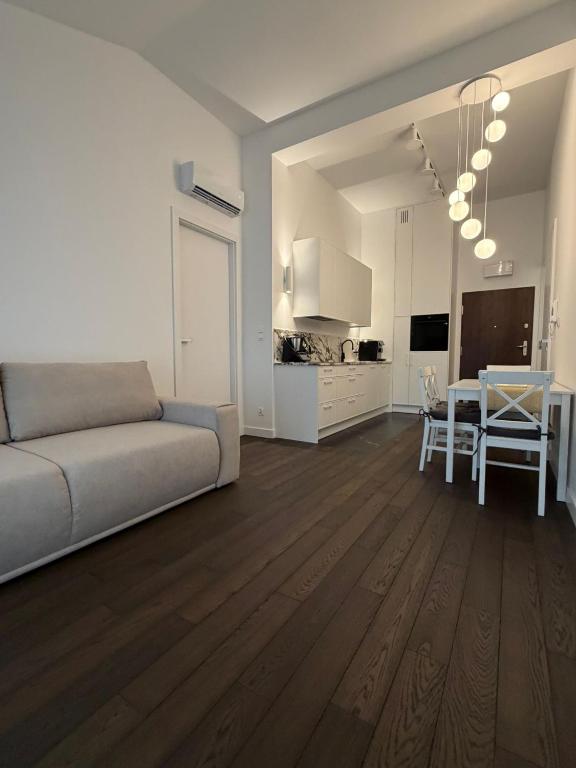 a living room with a couch and a dining room at Apartament Brzeg in Augustów