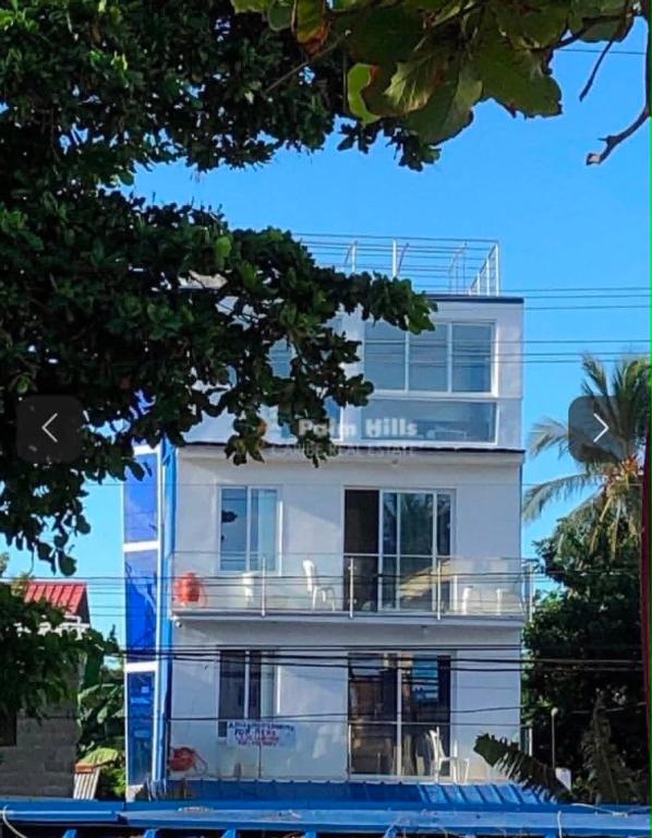 a large white building with a large balcony at Blue Flamingo Kite Beach in Cabarete