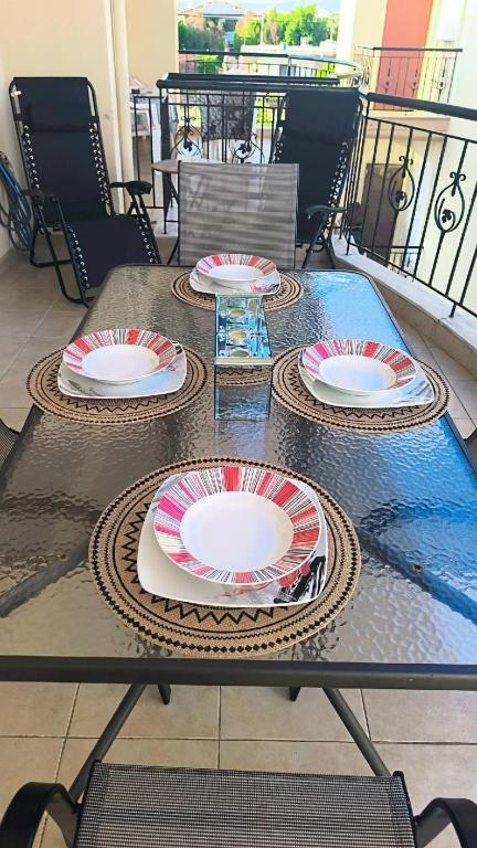three plates on a table on a balcony at Francesco's Apartment-Chalkidiki in Flogita