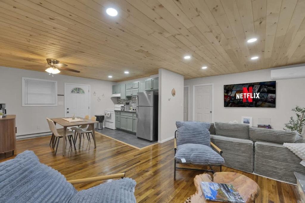 a living room with a couch and a table at Private Cozy Cabin with Fire Pit in Locust Lakes Village