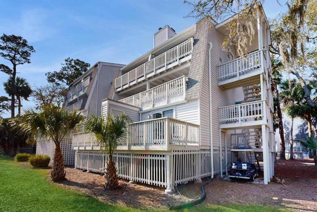 a large white building with trees in front of it at Driftwood Villa - 287 in Edisto Beach
