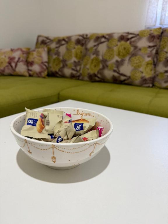 a bowl of toys on a table with a couch at Apartment Lunette in Mostar