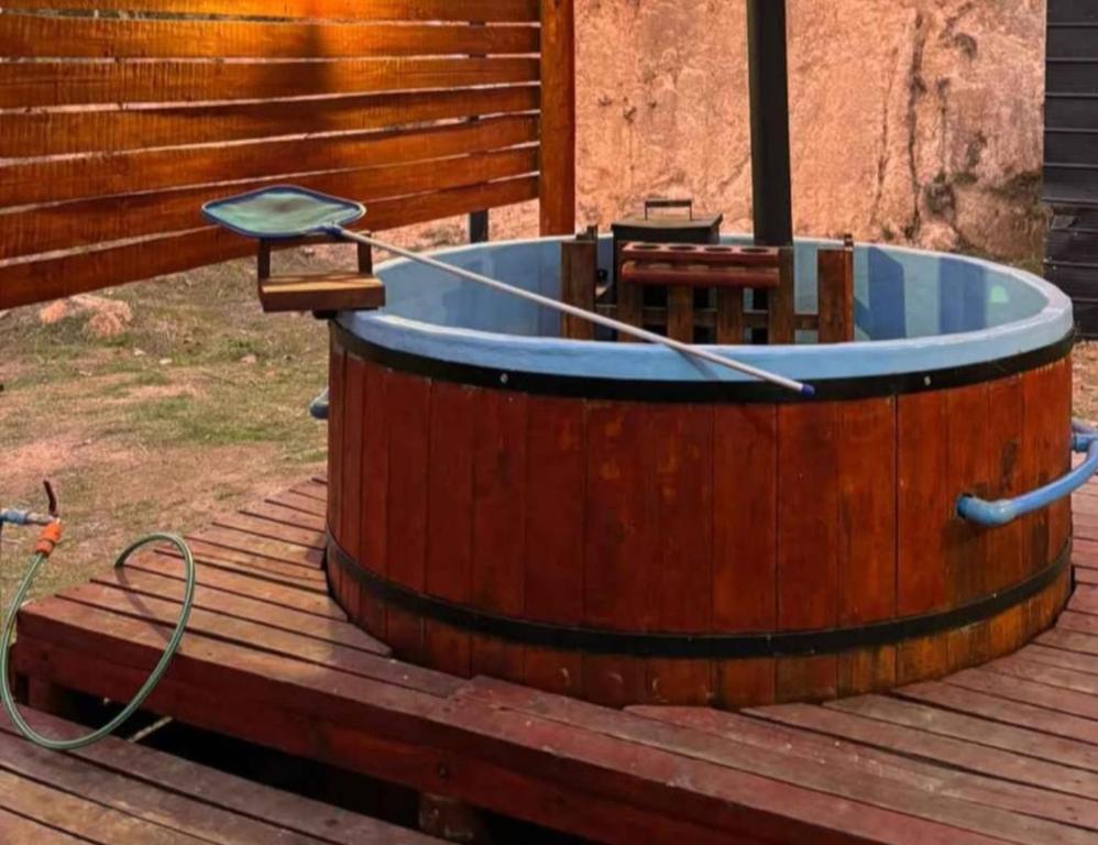 a wooden tub on a deck with a hose at Hospedaje marylin in La Serena
