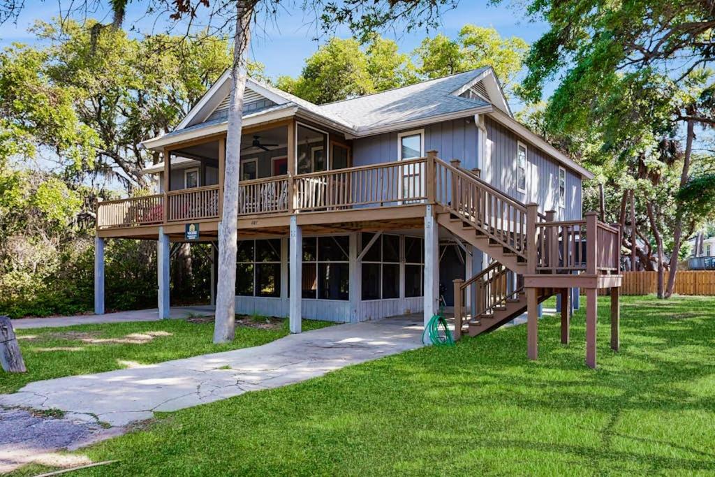 a large house with a large deck on the lawn at Cupid's Nest in Edisto Beach