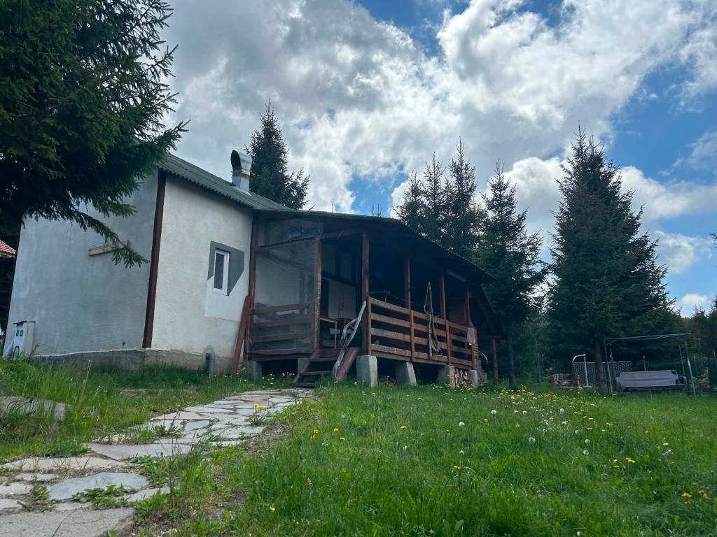 a house with the door open in a field at Lucky lak in Miercurea-Ciuc