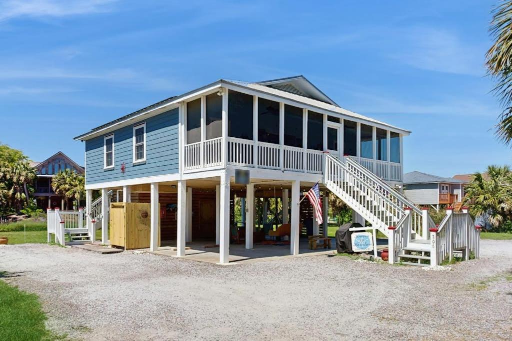 a large blue house with a staircase in front of it at Heaven on Harrelson in Edisto Beach