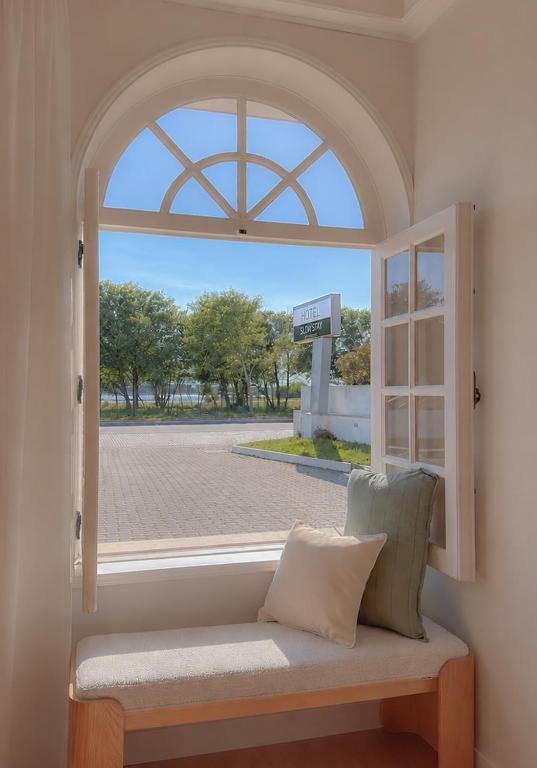 an open window with a bench looking out at a street at HOTEL SLOW STAY - Esposende in Esposende