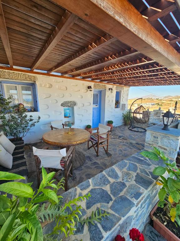 a patio with a table and chairs on a stone floor at Aspalathos I & ΙΙ in Kamárion