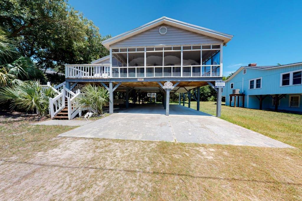a large house with a large porch with a balcony at Sand Quarters in Edisto Beach