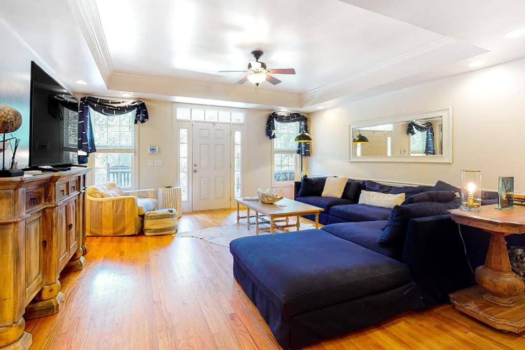 a living room with a blue couch and a table at Stare-Gazing in Edisto Beach