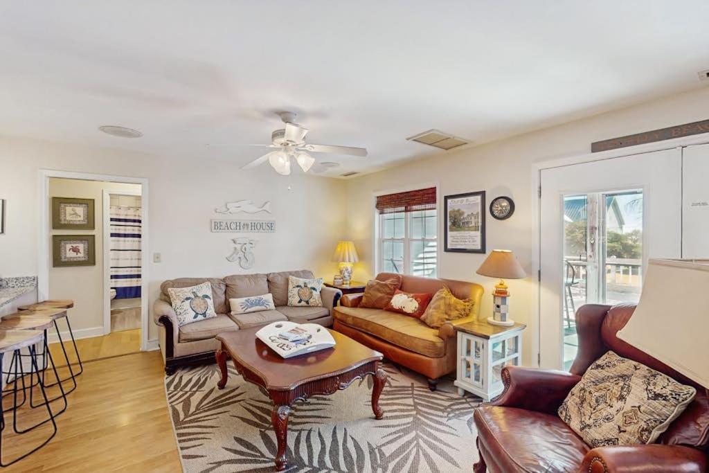 a living room with a couch and a table at Summer House in Edisto Beach