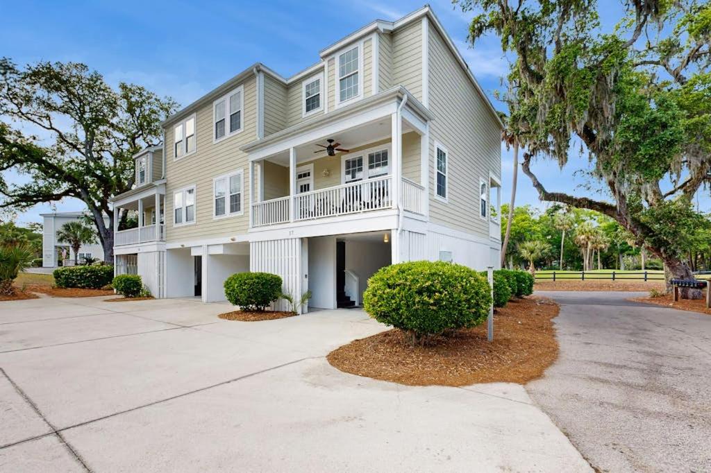 a large white house with a tree in front of it at King Cotton Villa 17 in Edisto Beach