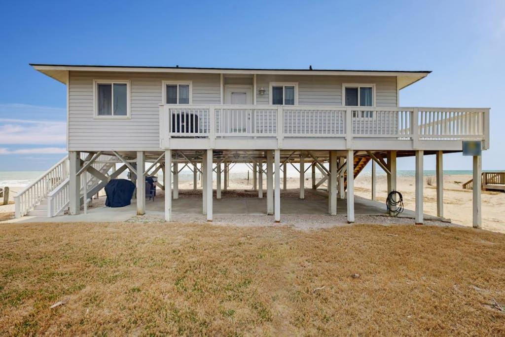 a large house on a beach with the ocean at Corrigan in Edisto Beach