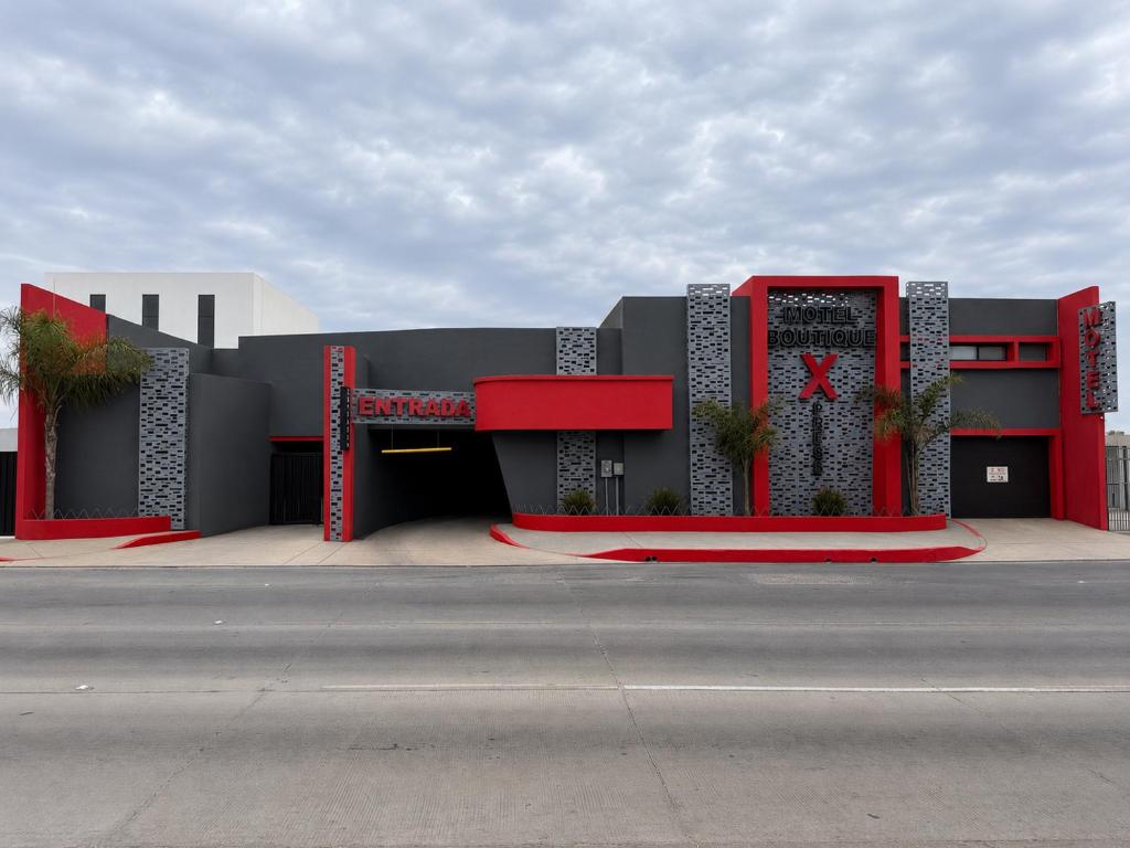 a building with red and black on a street at Motel Boutique Xpress in Ensenada