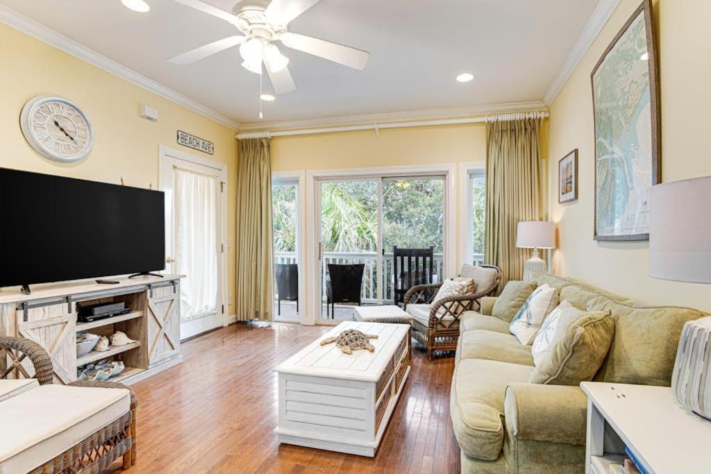 a living room with a couch and a tv at The Retreat 7A in Edisto Beach