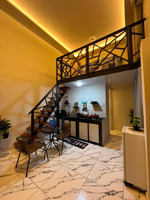 a living room with a loft bed and a desk at Munay House in Tarapoto