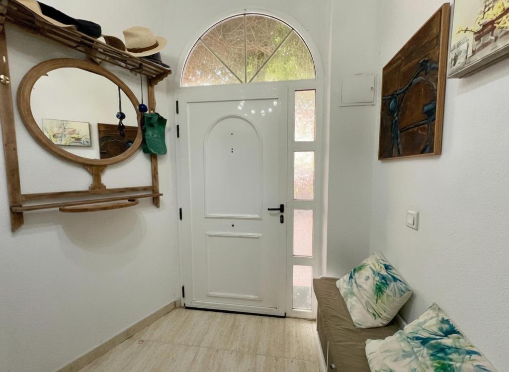 a living room with a white door and a mirror at Duna Hollidays in Puerto de Sagunto