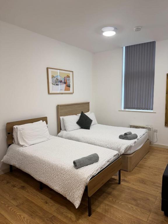 two beds sitting next to each other in a room at The Nest in Sheffield
