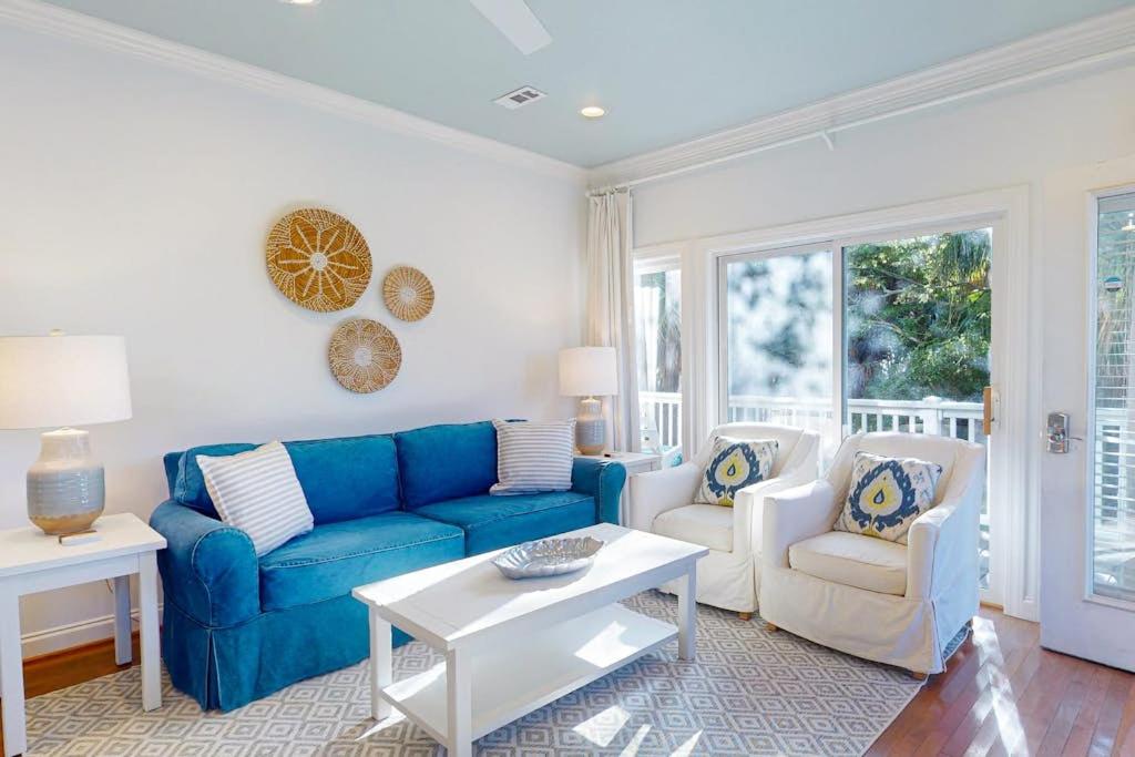 a living room with a blue couch and two chairs at Sea Sea Rider in Edisto Beach