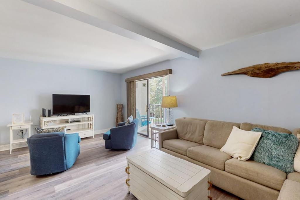 a living room with a couch and a tv at Xanadu D8 in Hilton Head Island
