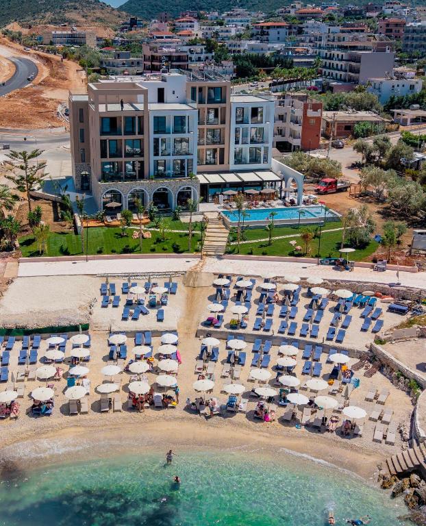 an aerial view of a beach with chairs and umbrellas at Hotel Camelot By Artur in Ksamil