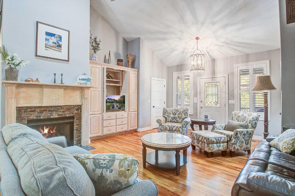 a living room with a couch and a fireplace at Why Knot? in Edisto Island