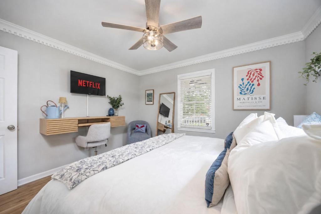 a bedroom with a bed and a ceiling fan at Lake Oliver Cottage Near Fort Benning & Downtown Columbus in Columbus