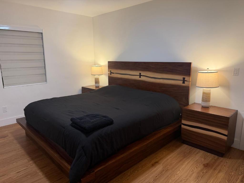 a bedroom with a large bed and two night stands at Casa paz in North Miami Beach