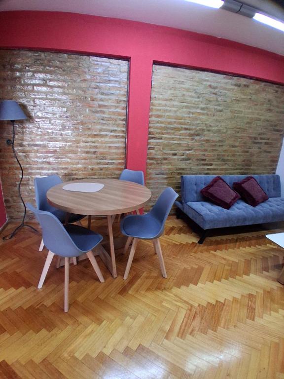 a room with a table and chairs and a couch at Departamento al Canal in Buenos Aires