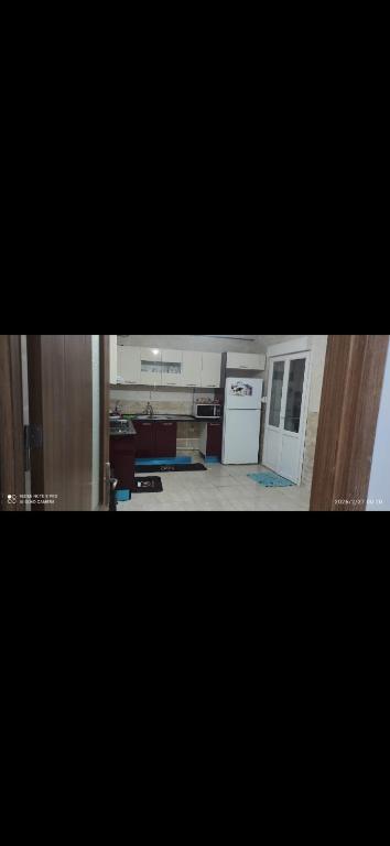 a kitchen with a white stove top oven next to a counter at Opera d'Alger in Ouled Fayet