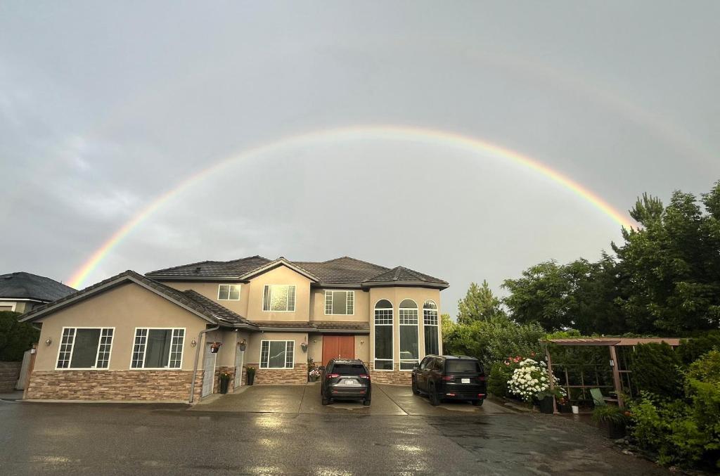 a rainbow in the sky over a house at 1 BDRM 1 BTH Suite with Private Entry in West Kelowna