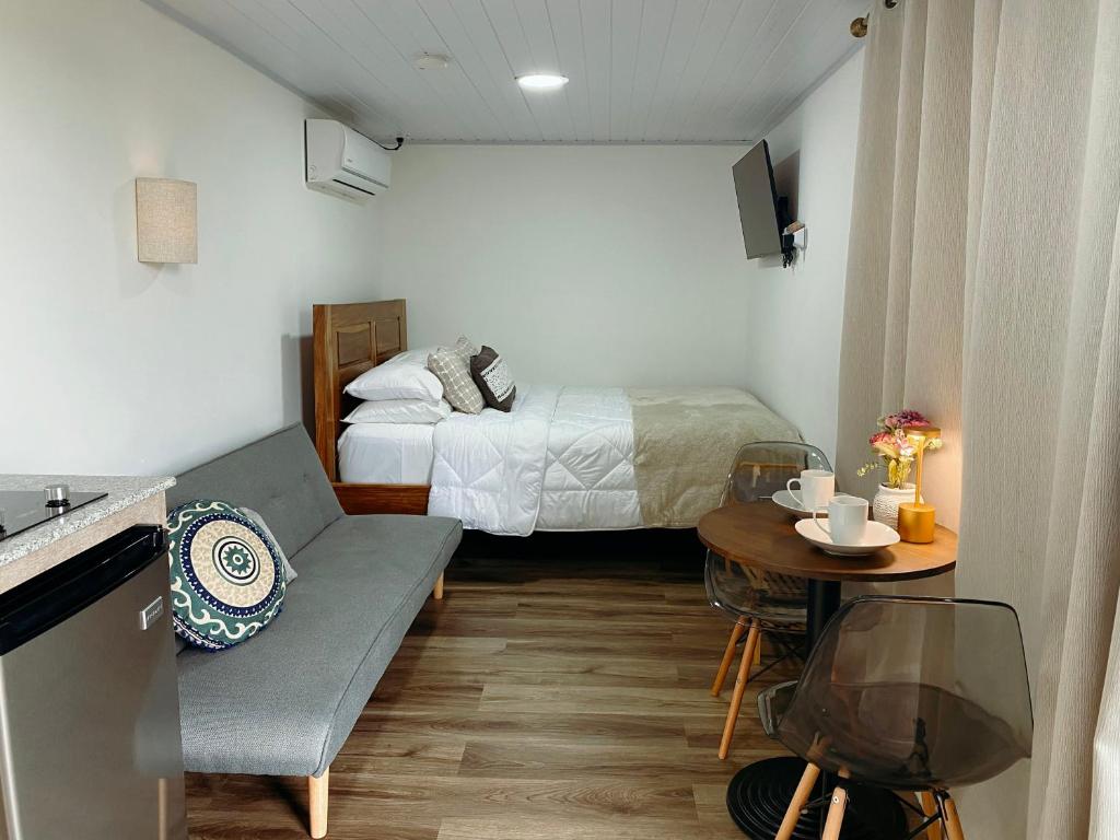 a small room with a bed and a table at Villa Cinco Boquete in Alto Boquete