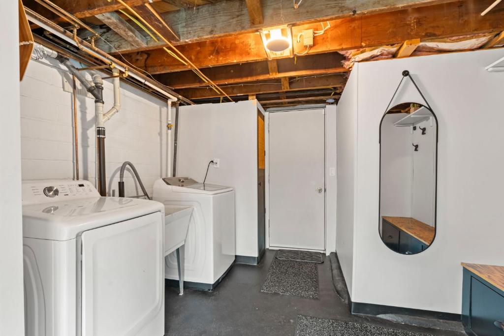 a bathroom with two sinks and a washing machine at Burban Bungalow in Maplewood