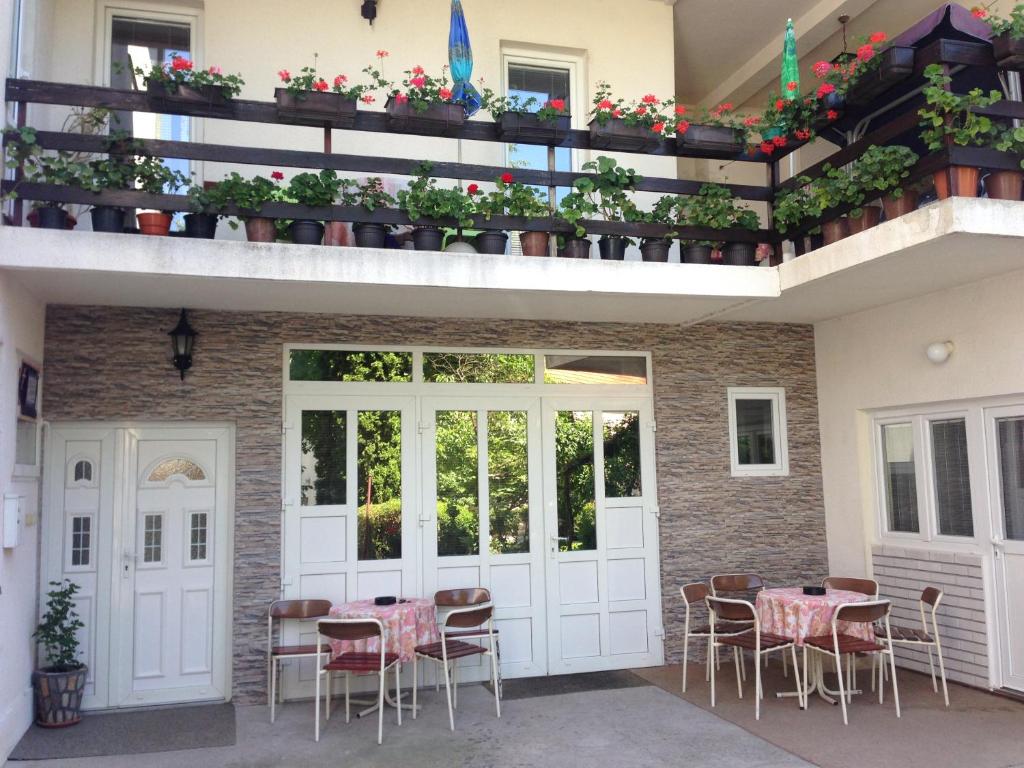 a patio with tables and chairs on a building at Apartments Božinović in Soko Banja