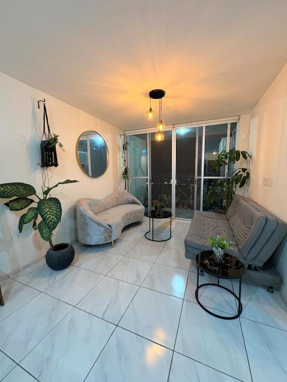 a living room with a couch and a table at The Hilltop Apartment in Guadalajara