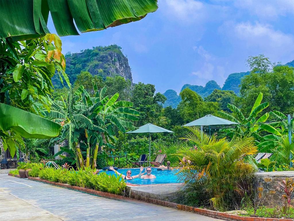 a pool at a resort with mountains in the background at The Sam Home in Nguyên Ngoại