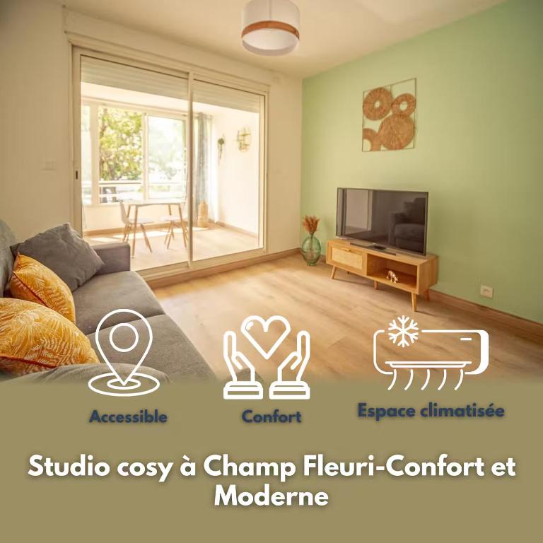 a living room with a couch and a tv at studio cosy - champ fleuri in Sainte-Clotilde