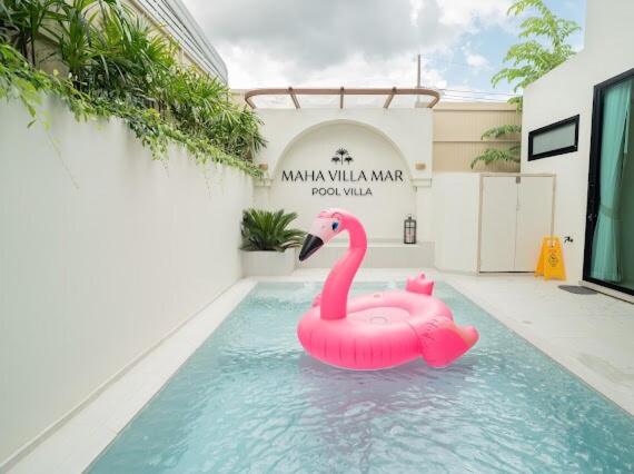 a pink swan in the water in a swimming pool at Villa Mar Pool Villa in Sathani Hat Yai