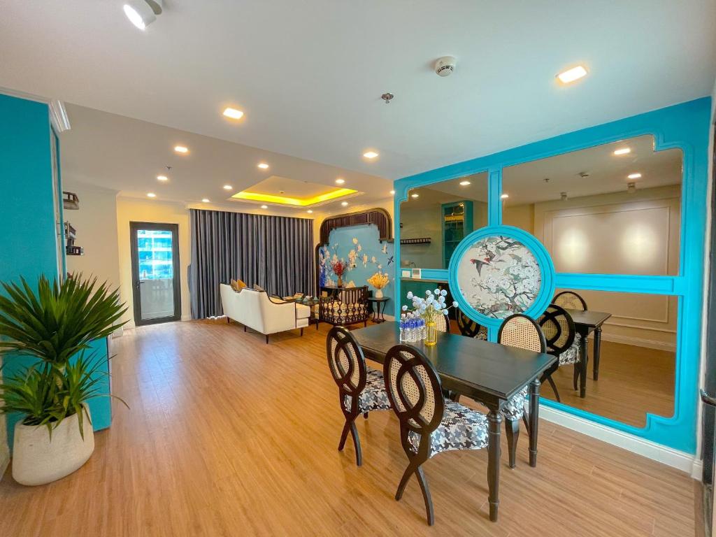 a dining room and living room with a table and chairs at FLC Sea Tower Quy Nhơn - View Biển in Quy Nhon