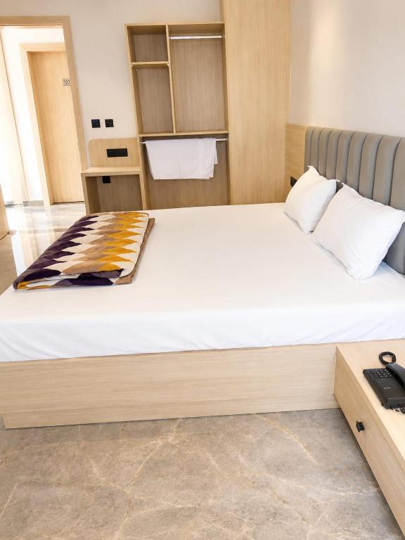 a bedroom with a large bed in a room at Hotel Radian INN in Gorakhpur