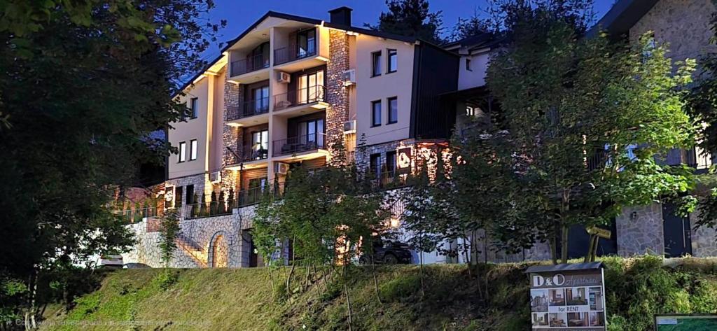 a large building with a sign in front of it at D & O Apartments in Mavrovo