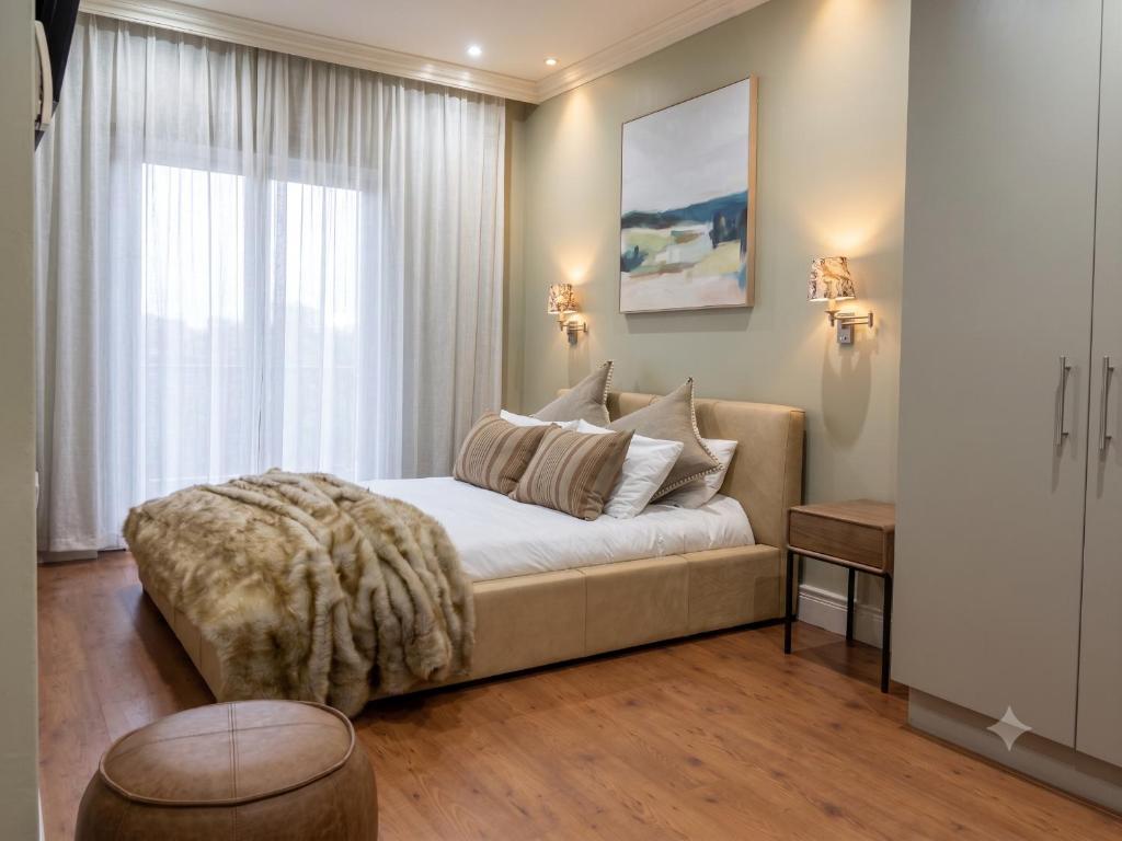 a bedroom with a bed and a large window at Cape Royale Luxury Suite 602 in Cape Town