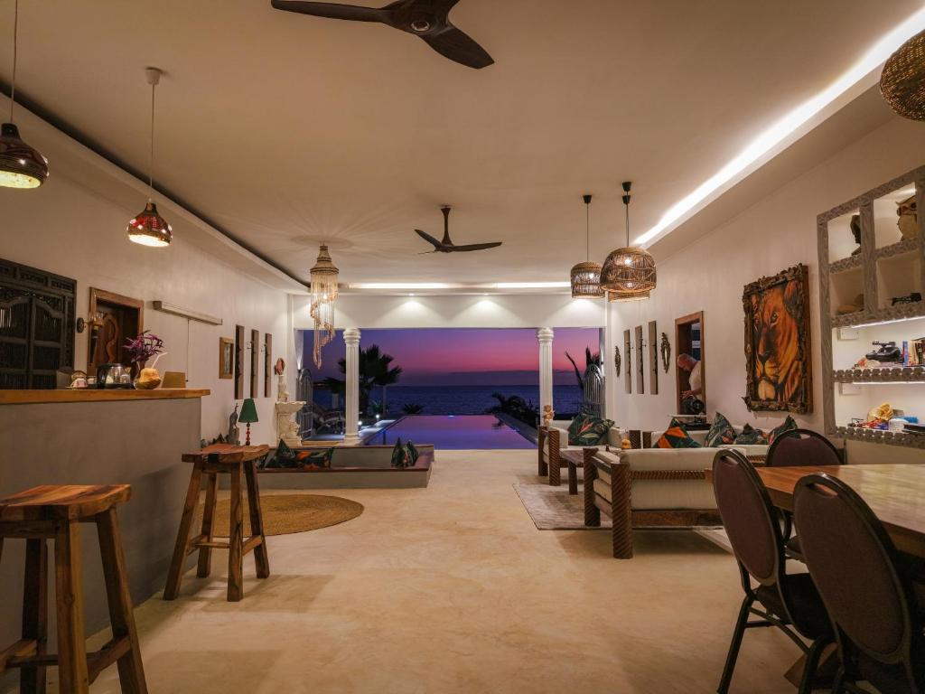 a living room with a couch and a table at beacfront villa claudius ,michamvi in Michamvi